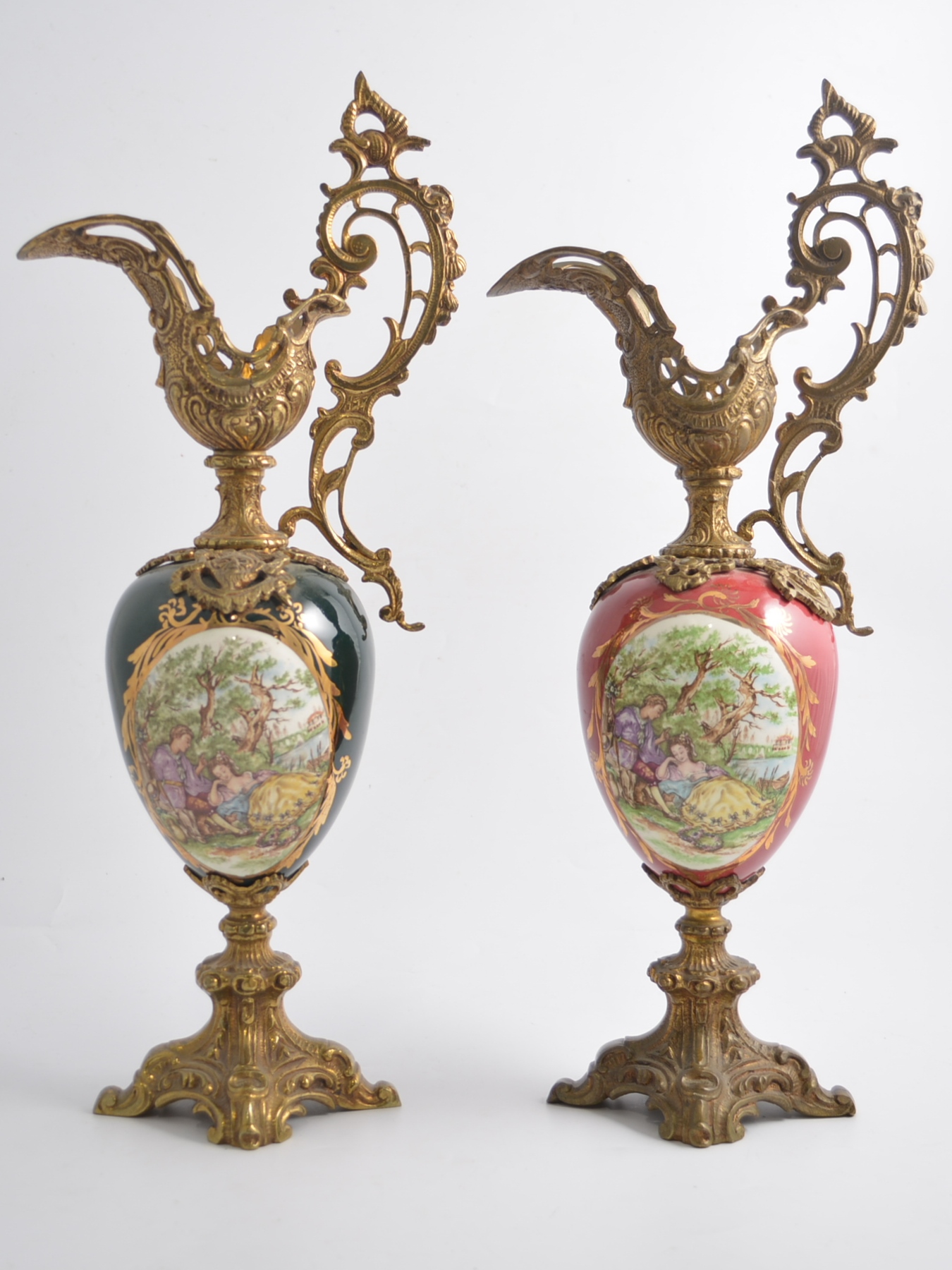 Pair of French gilded metal pedestal ewers, with pottery bodies.
