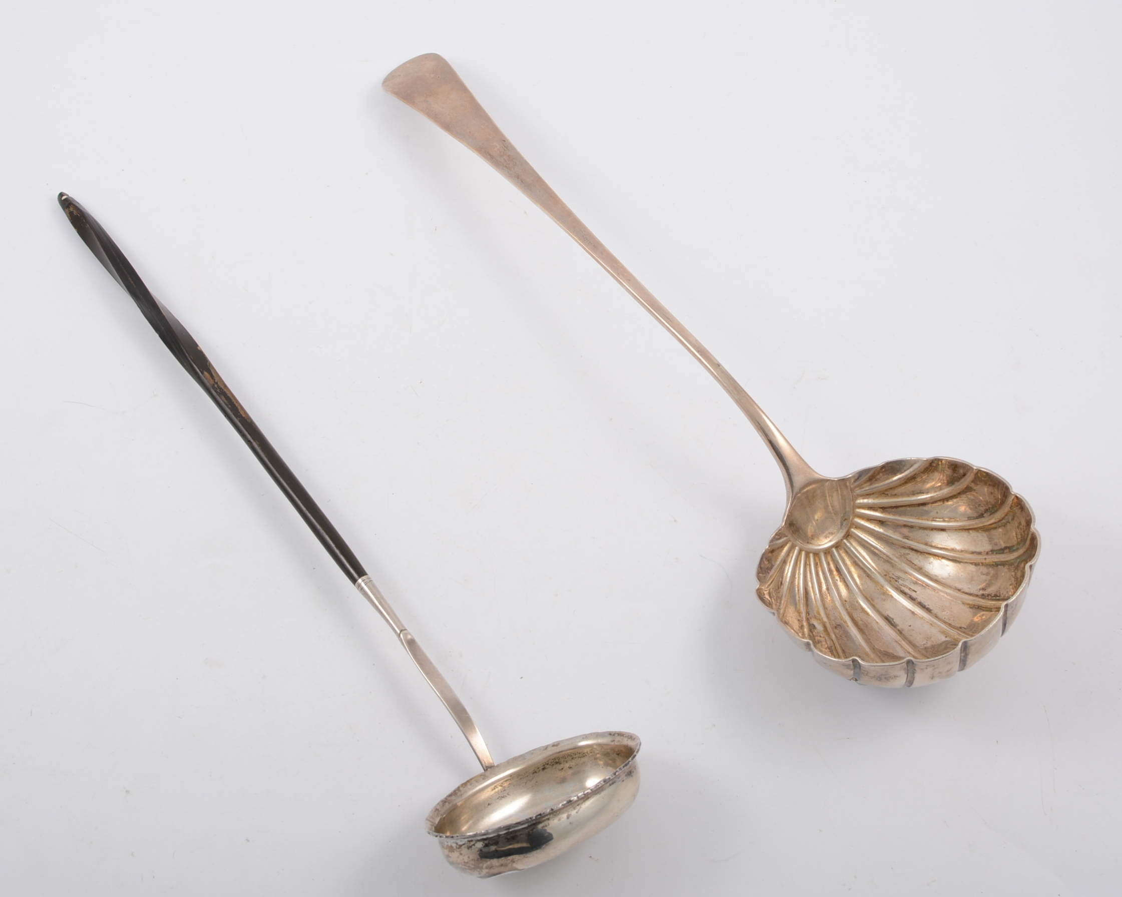 Two ladles, a toddy ladle inset with George II coin, a soup ladle with fluted bowl,