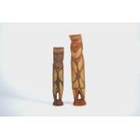 Two Oceanic carved softwood figures, heightened with red pigmentation, possibly New Caledonia,