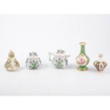 A German porcelain teapot, of small size, encrusted floral decoration, 10cm,