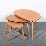 Ercol, a nest of three ‘Pebble’ tables, shape 354, elm and beech, applied blue and gilt label,