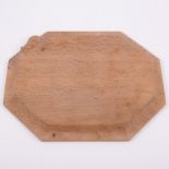 Robert 'Mouseman' Thompson of Kilburn, an oak octagonal bread board, carved signature mouse,