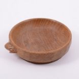 Robert 'Mouseman' Thompson of Kilburn, an oak circular dish, carved signature mouse to exterior rim,