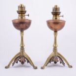 Pair of Victorian brass and copper oil lamps, in the manner of Benson, tripod bases, height 35.