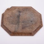 Robert 'Mouseman' Thompson of Kilburn, an oak octagonal bread board, carved signature mouse,
