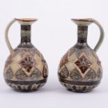 Doulton Lambeth, a pair of stoneware ewers, 1885, incised and beaded design,