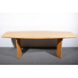 A Contemporary pippy oak dining table, 21st century, curved plank top with chamferred edge,