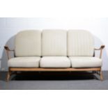 Ercol, a three seater settee with matching armchair, honey stained beech frames, spindle back,