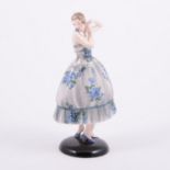 Goldscheider, an Art Deco ceramic figure of a lady, wearing a blue floral dress,