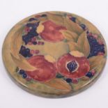 William Moorcroft, 'Pomegranate' an early box cover/ plaque, circa 1912, circular form,