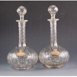 A pair of slice cut decanters, 31cm, with silver Port and Sherry labels by CJ Vander, London 1935.