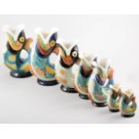 Set of five Dartmouth Pottery Gurgling fish jugs, painted colour glazes, one large,