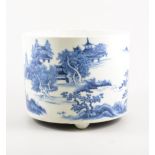 Chinese blue and white cylindrical jardiniere, painted with an extensive landscape on three feet,