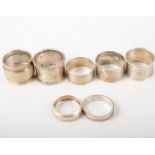 Seven hallmarked silver napkin rings, engine turned,