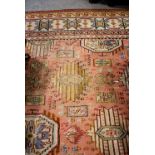 Early machine made carpet, salmon field with multiple lanterns, enclosed by broad borders,
