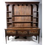 18th century oak dresser base, with later delft rack, moulded cornice with shaped skirt,