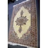 Woollen carpet, central floral medallion on a cream ground,