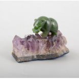 Small malachite model of a bear, set on a natural amethyst base, overall 8cm.