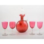 Cranberry glass decanter, with stopper, 26cm, and four glasses, (5).