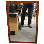 Pair of framed bevelled mirrors with carved relief, 100cm x 47cm overall; and one other.