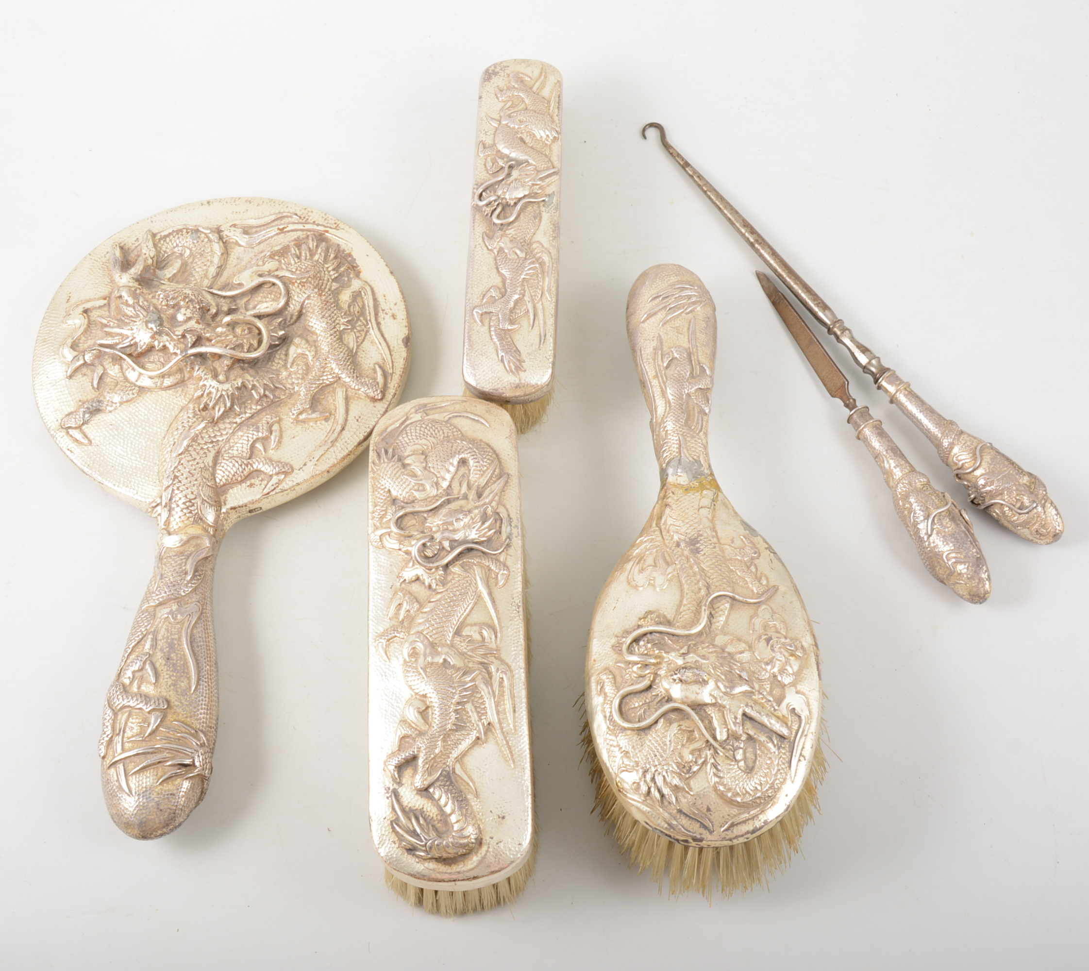 Chinese white metal four-piece dressing table set, embossed decoration of dragons,