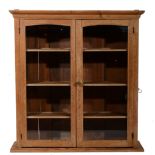 Pine two-door cabinet, with glazed panelled doors, width 101cm, depth 28cm, height 108cm.