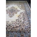 Indo-Persian carpet, central floral medallion enclosed by similar spandrels on a cream field,