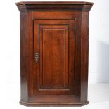 George III oak hanging corner cupboard, with canted corners,