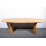 A Contemporary pippy oak dining table, 21st century, curved plank top with chamfered edge,