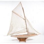 Columbia model yacht on stand, 123cm long.
