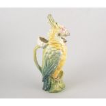 Continental ceramic jug in the form of a parrot, the handle a flower stalk, 35cm high.