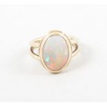 An opal dress ring, the oval cabochon cut stone, 14mm x 9mm,