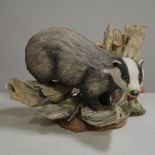 Boehm Bone Porcelain figure of a Badger, modelled climbing over a log with toadstools, dated 1982,