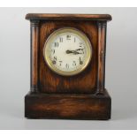 Oak cased mantel clock, USA spring movement striking on a gong, 31cm.