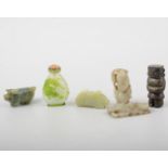 Two carved jade weights, three small figures and a snuff bottle.
