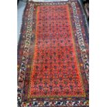 Late 19th/ early 20th century wool rug, madder red field with multiple botehs,