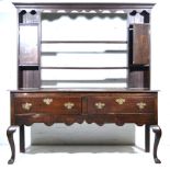 Late Victorian oak dresser, cavetto moulded cornice, above a shaped apron,