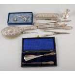 Collection of silver handled button hooks; shoe horn; glove stretchers; dwarf candlestick;