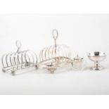 Three silver-plated toast racks, sauce boat, silver picture frame, silver lidded glass mustard,