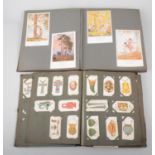 Postcard album, mostly cards by Margaret Tarrant, together with an album of cigarette cards.