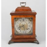 A walnut cased bracket clock, square dial with cast spandrel, signed Prescott,