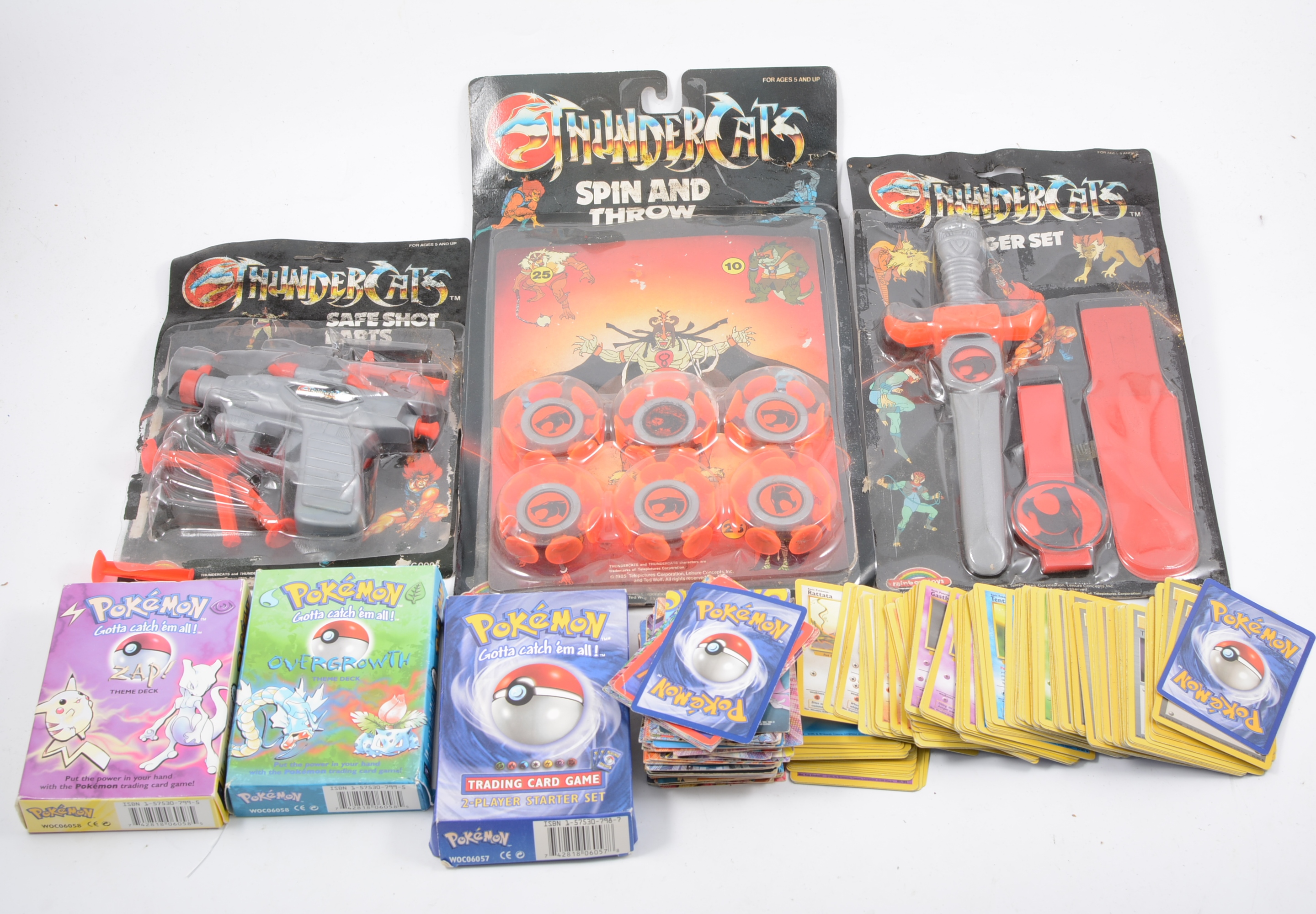 Thundercats toys in blister packs, along with a selection of vintage Pokemon cards, one box.