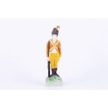 Staffordshire underglaze painted earthenware figure of a soldier at attention, circa 1780-1800,