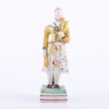 Staffordshire earthenware figure of lady juggler, circa 1820-30, overglaze enamel decoration,