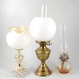 Modern brass oil lamp, with chimney and opaque shade, 51cm; another oil lamp and a table lamp.