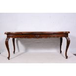 French stained beech draw-leaf dining table, the top with shaped outlines,