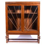 1930s oak bookcase, rectangular top with a moulded edge, carved frieze,