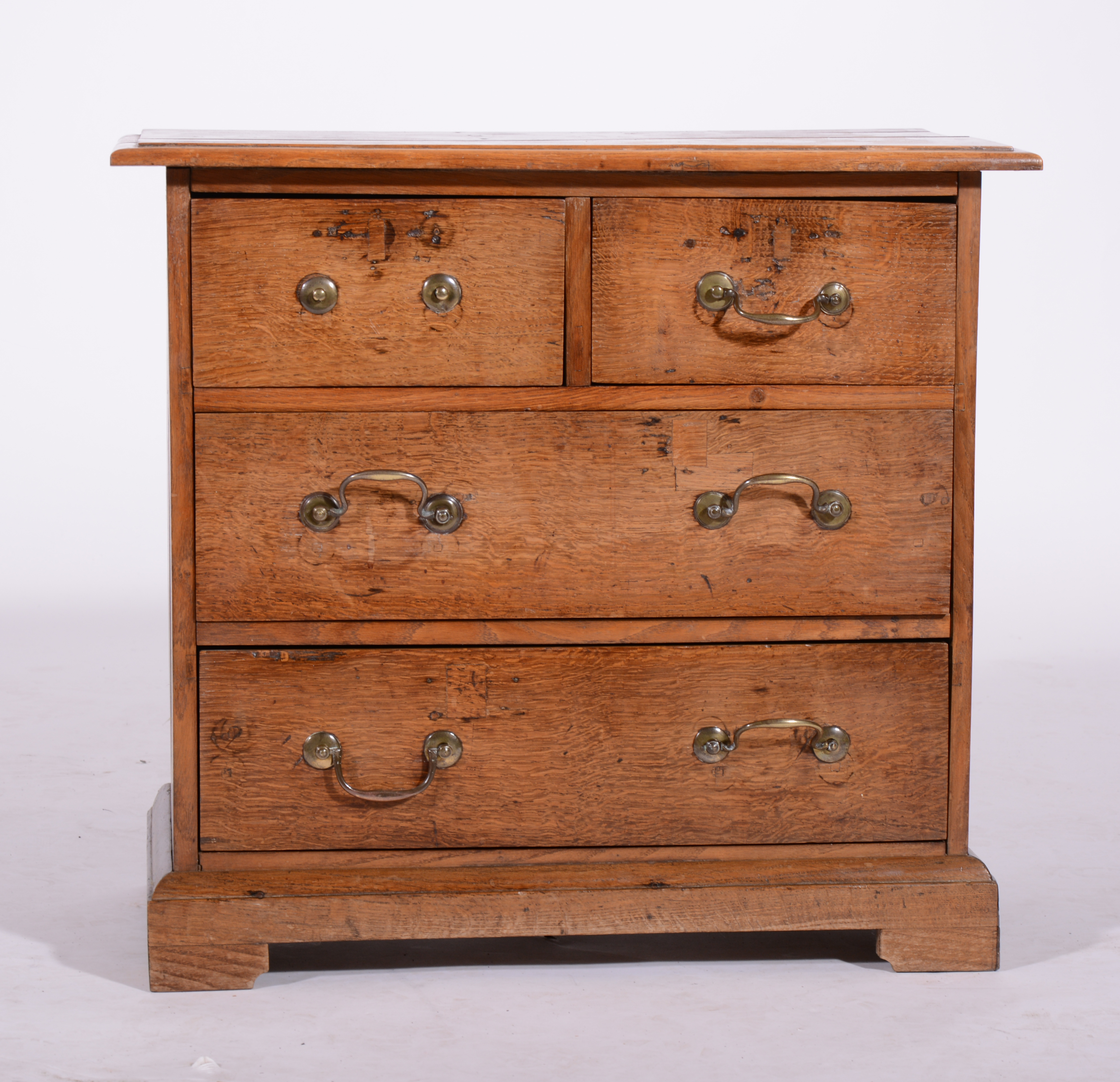 Small oak chest of drawers, fitted with two short and two long drawers, bracket feet, 69cm,