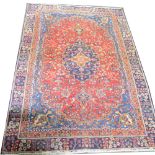 Tabriz patterned rug, central medallion on a pattern red field, blue ground spandrels,