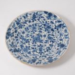 A delft ware plate, decorated in a blue floral design 22cm diameter.
